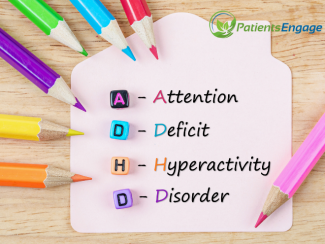 A post it with coloured pencils arranged around it and full form of ADHD - Attention Deficit Hyperactivity Disorder written on the post it