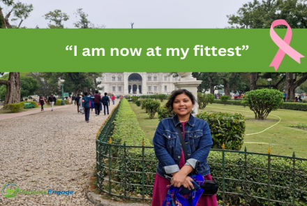 Picture of a young woman, a breast cancer survivor in denim jacker and a red dress in front of Victoria Memorial and text overlay I am now at my fittest 