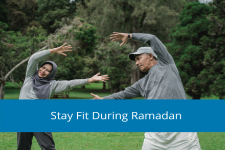 Image of a muslim woman and man exercising in the park with text overlay stay fit during Ramadan 