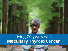 Picture of a man in front of trees with the text Living 26 years with Medullary Thyroid Cancer on a blue strip