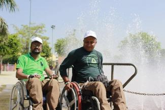 Image of two wheelchair users at a water adventure park