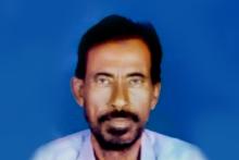 Frontal shot of a dark haired and bearded person