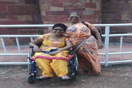 Smitha Sadasivan, who has Multiple Sclerosis on a wheelchair accompanied by her mother