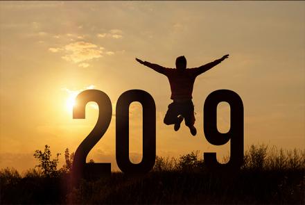 A stock pic that has the numbers 2019 with the 1 replaced by a jumping joyous vector image