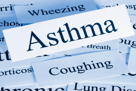 Pic of words like wheezing coughing and Asthma with a focus on Asthma 