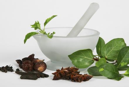 Image shows herbs and a mortar and pestle
