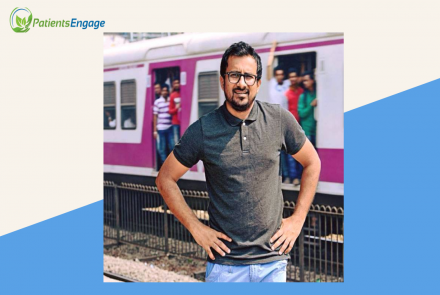 Profile image of a man in grey shirt and blue jeans in front of the mumbai metro 