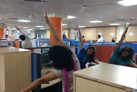 Image: Employees working out next to their desks