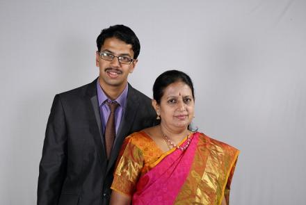 Image: Autistic adult Pranav in a suit with his mother in a red sari and gold border