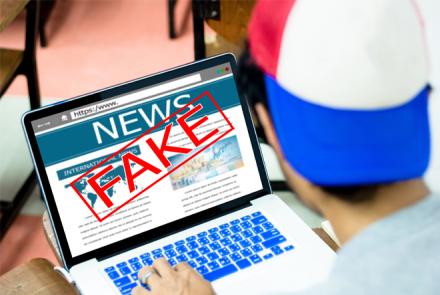 Stock pic with the word FAKE over the news on a laptop
