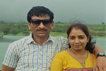 Vijay Bhende in a white shirt on the left with his wife in a yellow kurta on the right