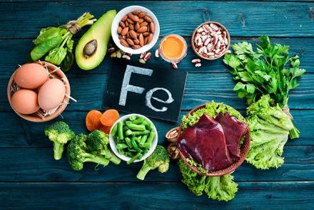 Stock pic of Fe the chemical symbol for iron surrounded by iron rich foods 