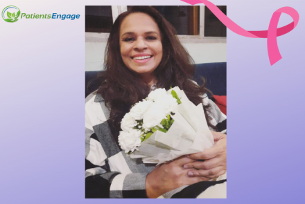 Mukta holding a bouquet of white flowers and a pink ribbon as a design element for breast cancer