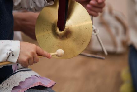 A girl playing cymbals