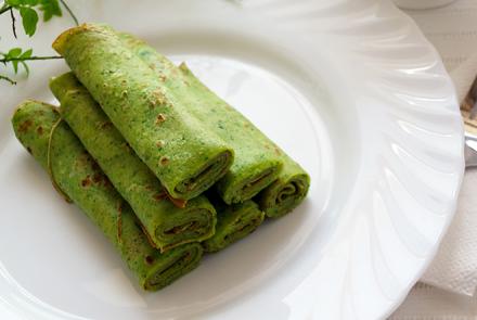 A plate of rolled cheela - crepe made from sprouted green gram and chickpeas 