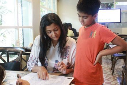 Image: A woman and a young boy looking at the special menu for dyslexia awareness