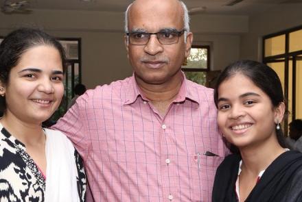 Mr. Aleem Baig in the centre in a pink shirt flanked by his 2 daughters who have thalassemia major