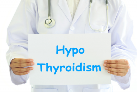 Partial image of a doctor with a stethoscope holding a white sheet with the text HypoThyroidism
